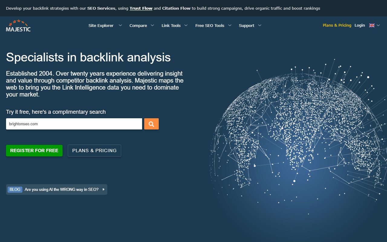 Majestic homepage: navy background, headline "Specialists in backlink analysis", a search box pre-filled with brightonseo.com and a globe drawn in white dots and lines